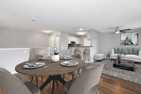 Virtually staged dining and living area at Summit Townhomes in Burnsville, MN, with breakfast bar seating.
