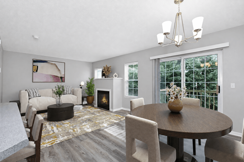 A modern living room with a fireplace and a dining table set for four.