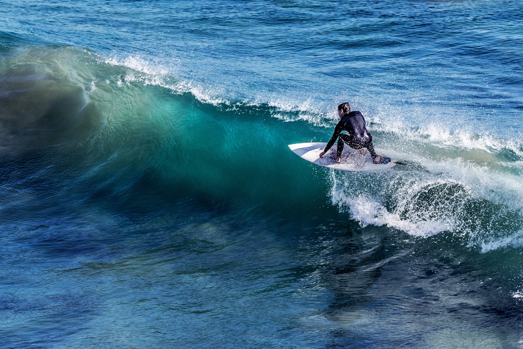 a surfer riding a wave in the ocean