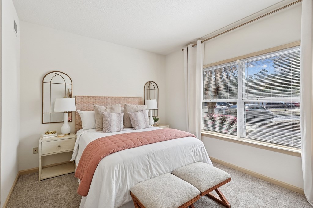 Spacious bedroom with natural light and neutral decor in Tattersall Village Apartments, Hinesville, GA