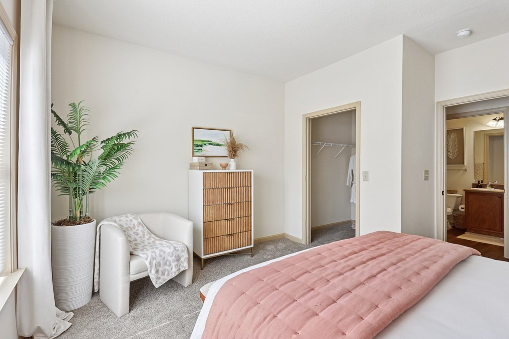 Well-lit bedroom with soft tones and ample closet space at Tattersall Village Apartments, Hinesville, Georgia