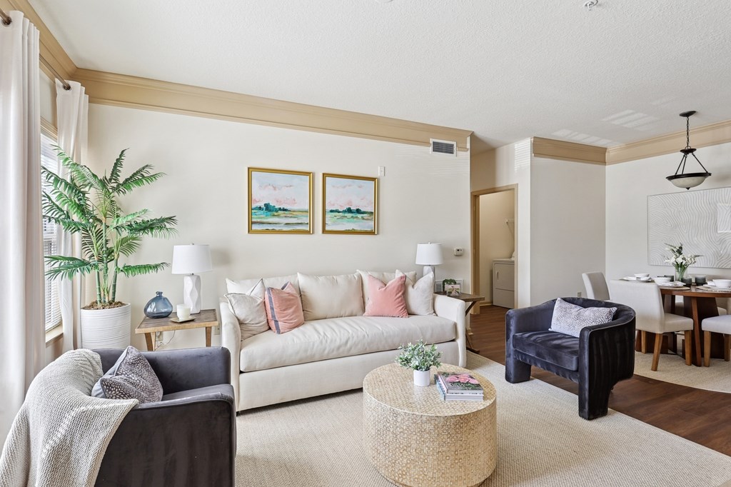 Comfortable and pet-friendly living room with neutral decor at Tattersall Village Apartments in Hinesville, Georgia
