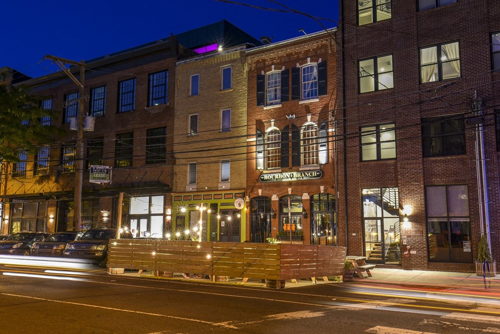 a large brick building on a city street at night
