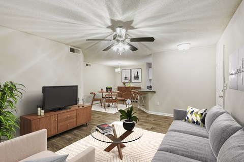 A living room with a grey couch and a wooden coffee table.