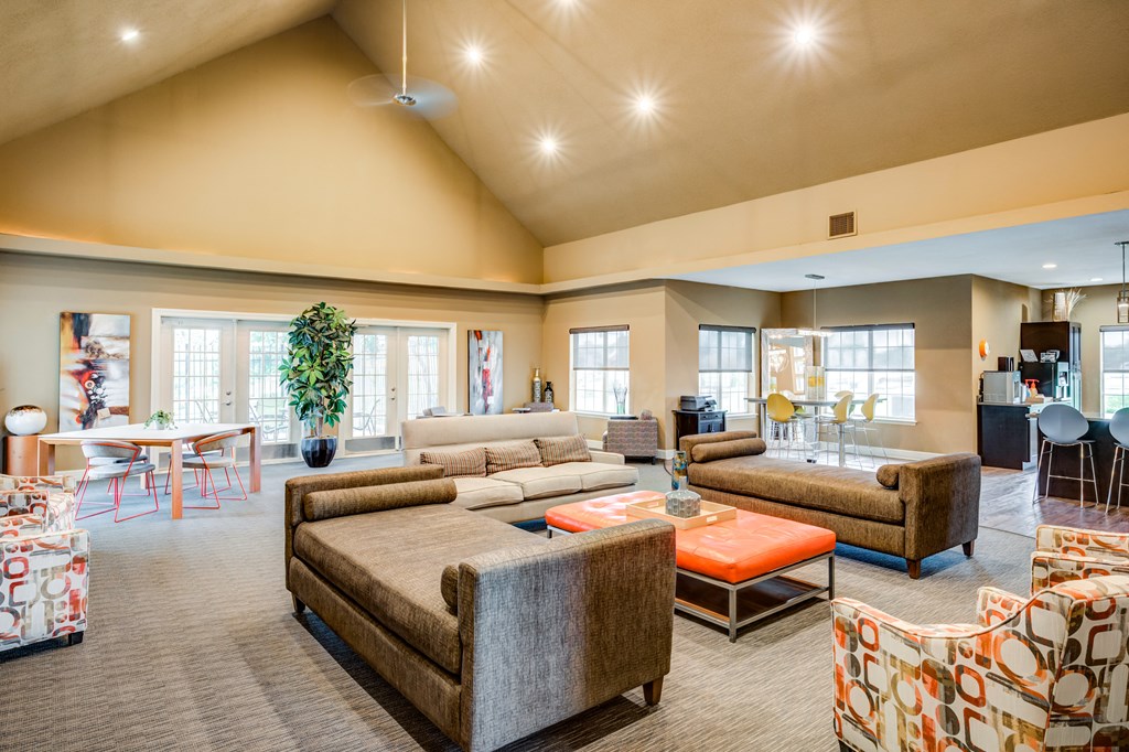 a large living room with couches and chairs