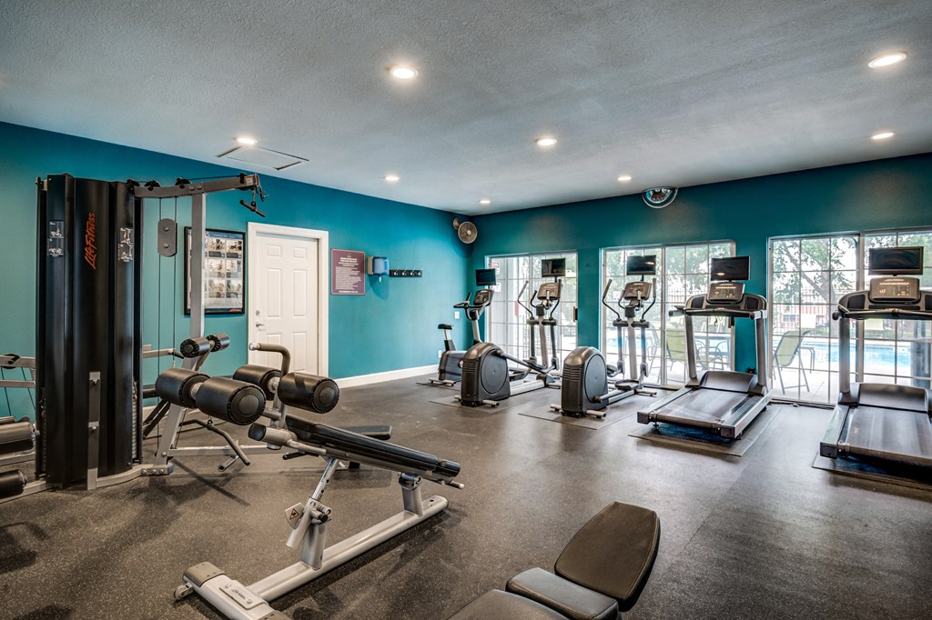 Apartment gym with exercise equipment and a large window