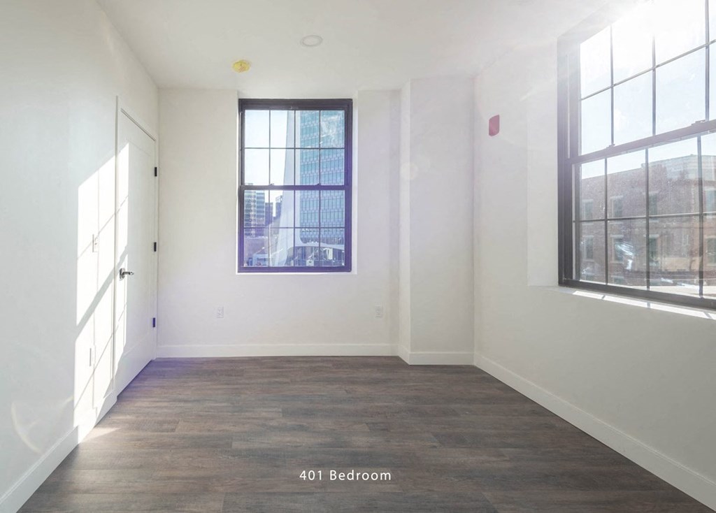 an empty room with white walls and a window