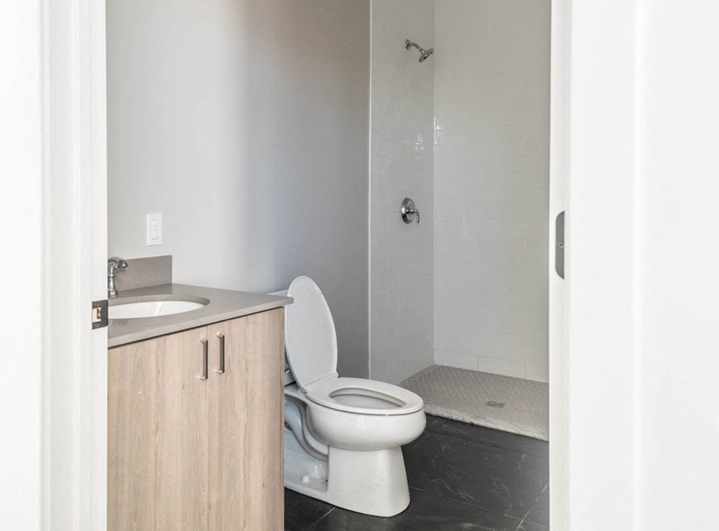 an empty bathroom with a toilet and a shower