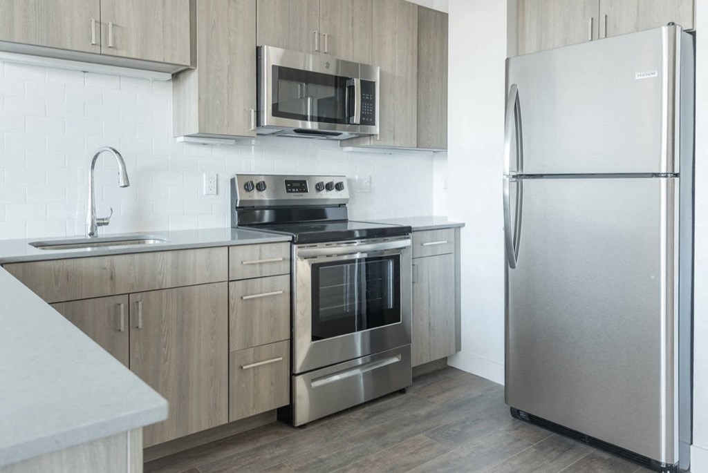 a kitchen with stainless steel appliances and wooden cabinets