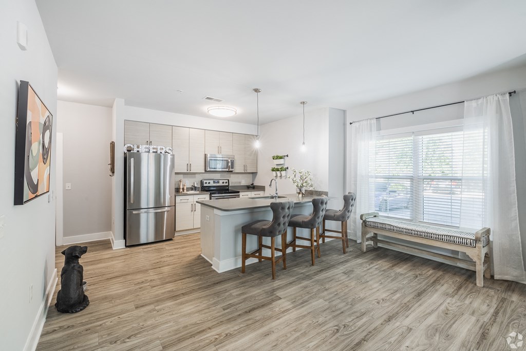 an open kitchen and dining area with a stainless steel refrigerator at The Ashley, Charleston, South Carolina, 29407