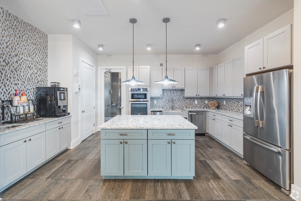 a large white kitchen with stainless steel appliances and a marble counter top t The Ashley, South Carolina, 29407