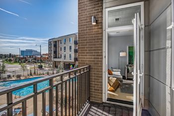 a balcony with a pool and a view of the city