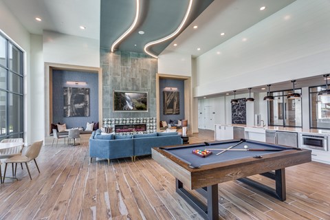 a game room with a pool table and a blue couch