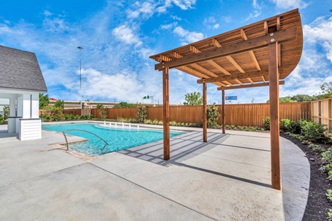 a backyard with a pool and a pergola