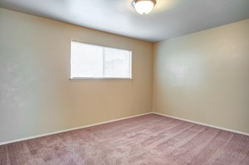 One Bedroom Apartments in Turlock CA - Briarwood Apartments Bedroom with a Spacious Layout, Window, and a Light Fixture - Photo Gallery 6