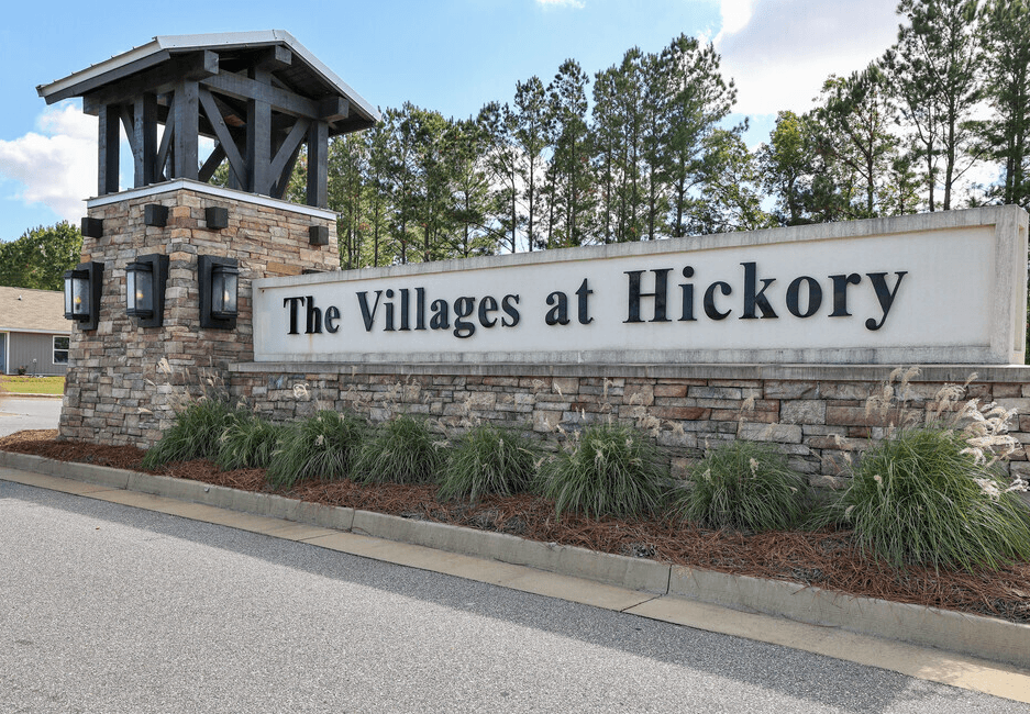 the villages at hickory sign at the entrance of the village