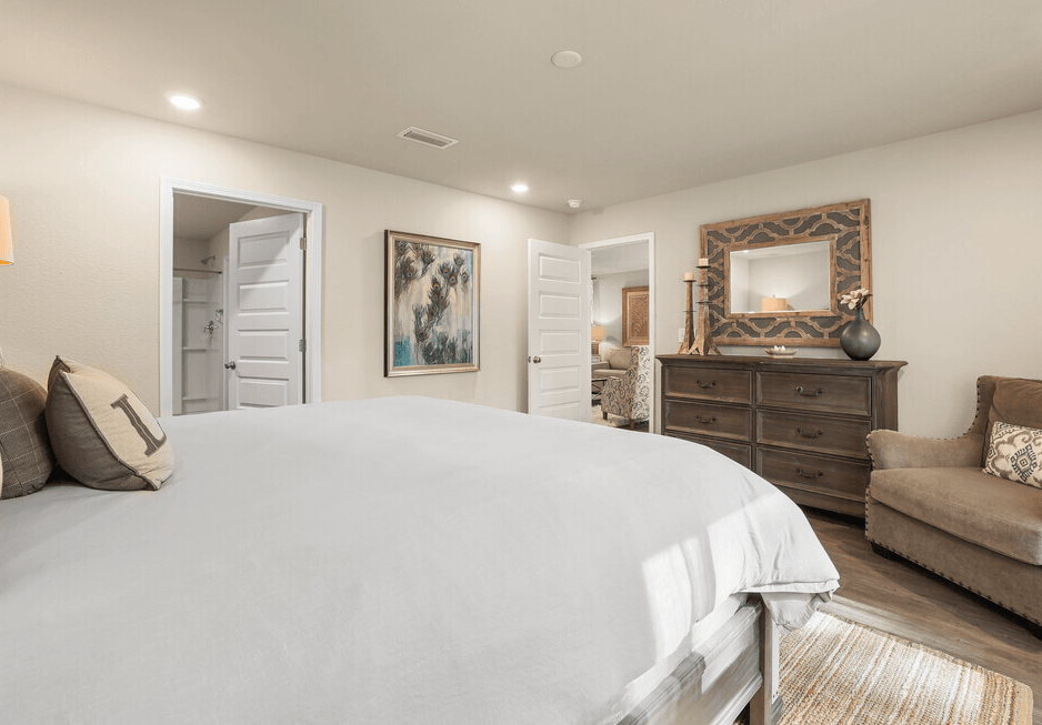 a master bedroom with a large bed and a couch