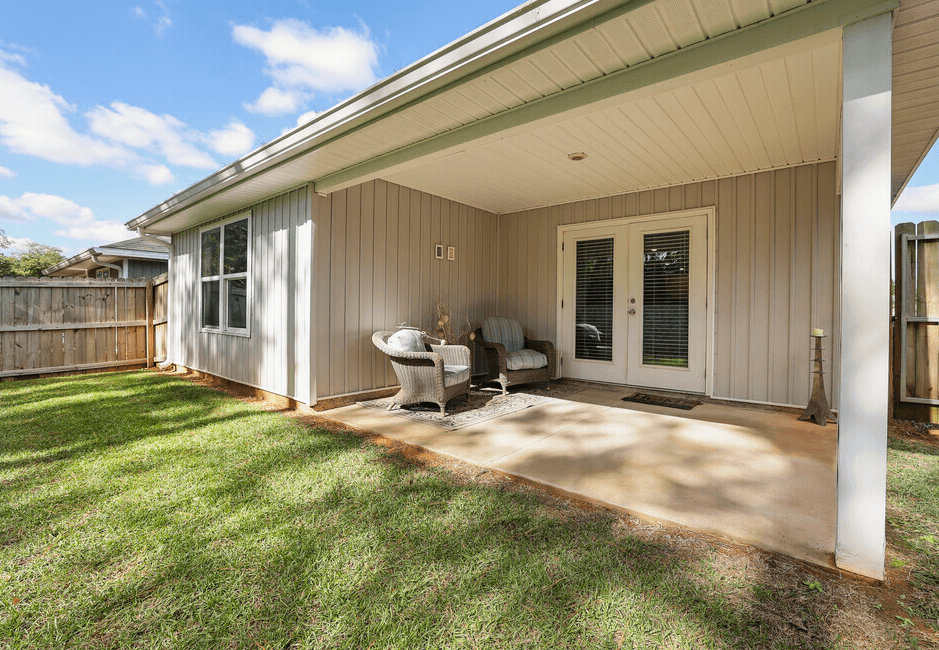 a patio in front of a house with a chair on it