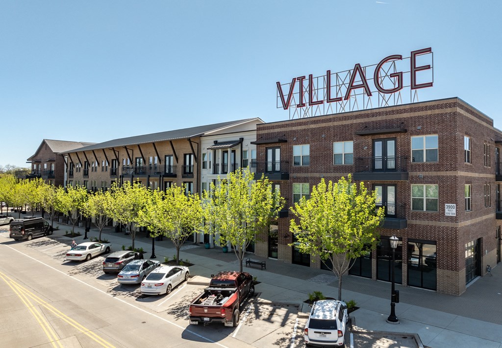 a large building with a sign on the side of a street