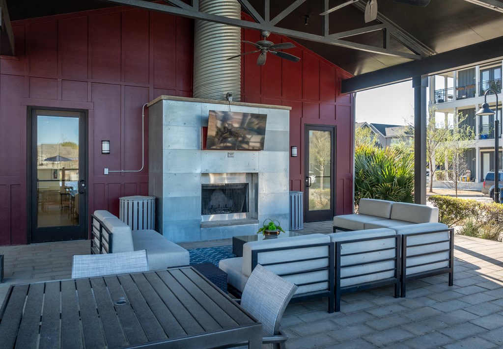 a living room with a fireplace and a table and chairs