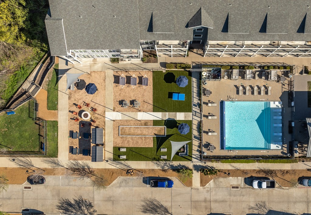 arial view of a house with a swimming pool and lawn
