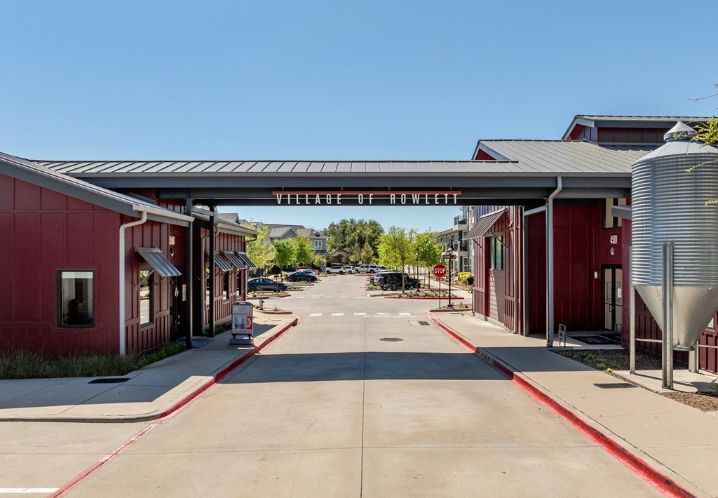 a row of red buildings with awnings over a street