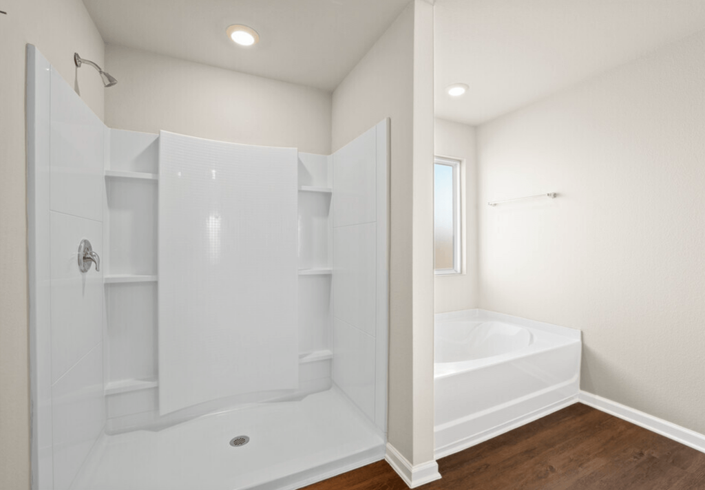 a white bathroom with a tub and shower and a closet