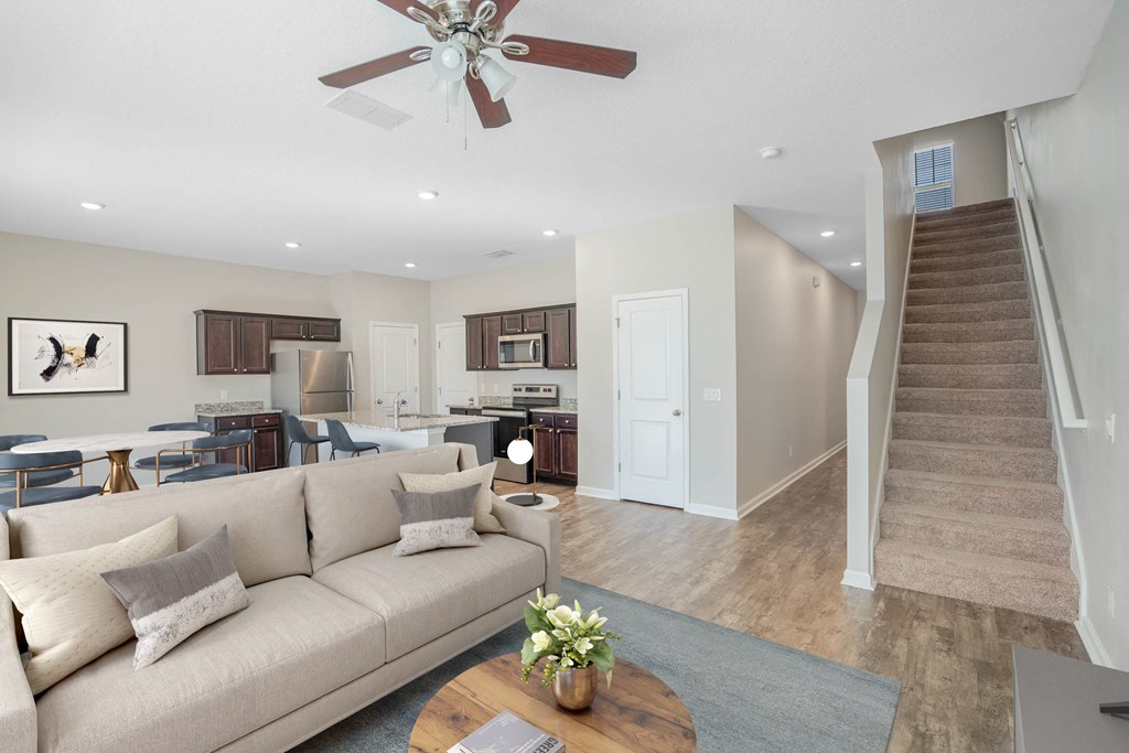 A living room with a beige couch and a coffee table.