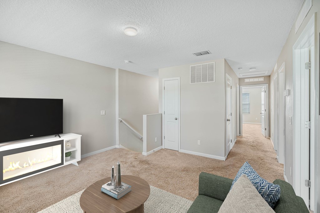 A living room with a television and a couch.