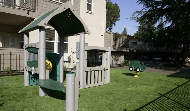 a playset in the backyard of a house