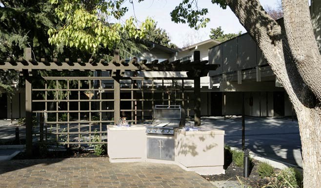 an outdoor kitchen with a stove and a microwave