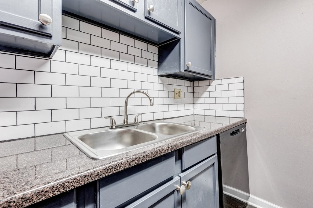 Whitney Manor Apartments in Gretna, LA photo of  a kitchen with a sink and white subway tiles