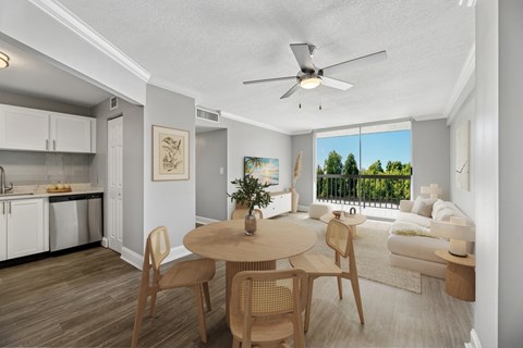 A modern kitchen with a dining table and chairs.