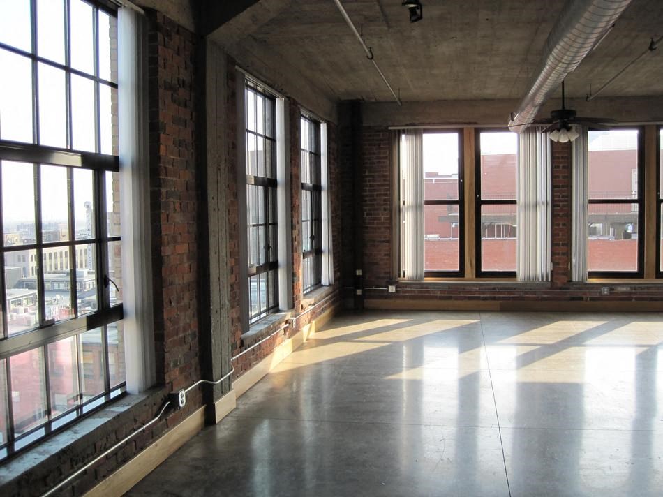 an empty room with a bunch of windows