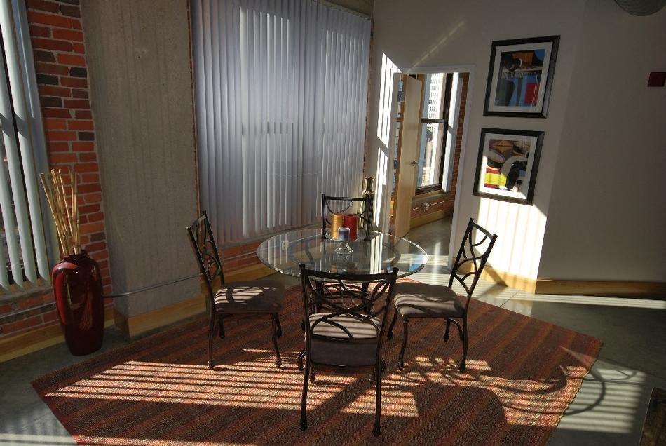 a dining room with a glass table and chairs