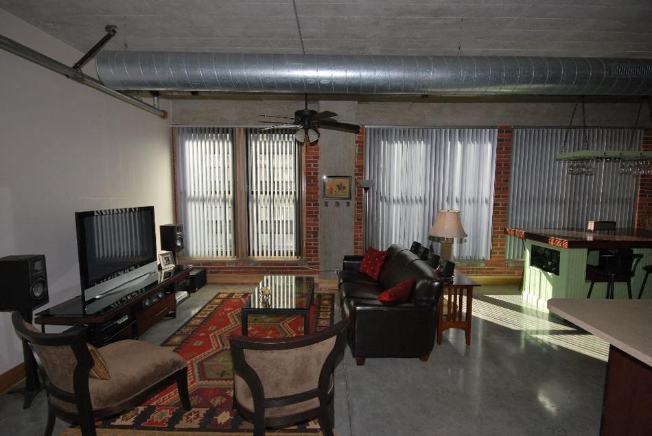 a living room filled with furniture and a flat screen tv