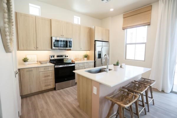 A kitchen with wooden cabinets and a white countertop.
