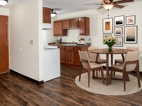 a kitchen and dining room with a table and chairs