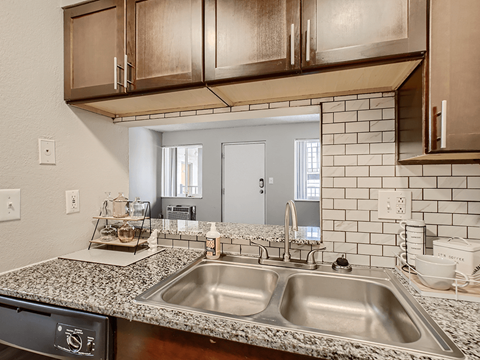 the kitchen has granite counter tops and stainless steel appliances