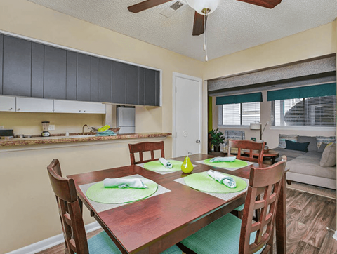 a dining room and kitchen with a table and chairs