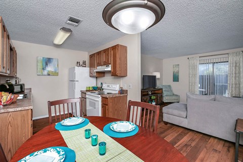a kitchen and dining room with a table and chairs