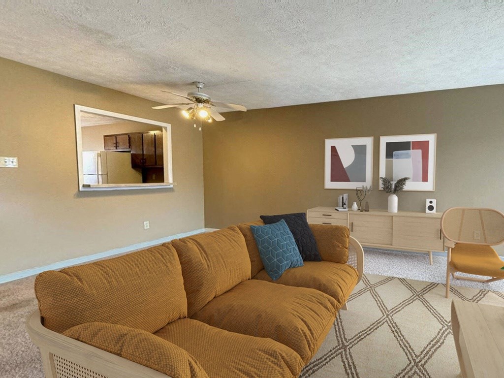 a living room with a couch and a ceiling fan