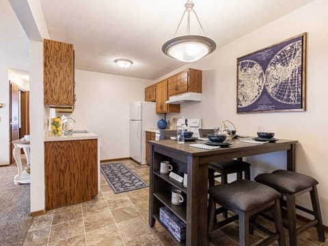a kitchen with a bar and a dining table