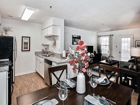 a kitchen and dining room with a table and chairs