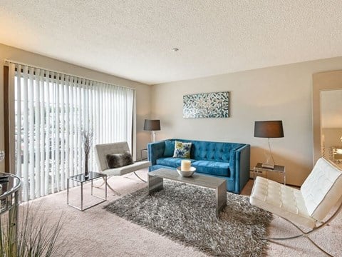 a living room with a blue couch and a table