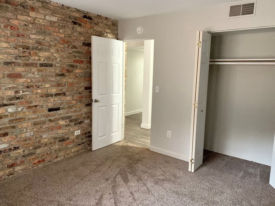 bedroom with brick wall