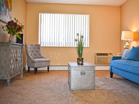 a living room with a blue couch and a chair