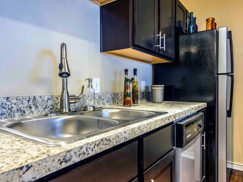a kitchen with a sink and a refrigerator
