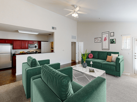 a living room with green couches and a table