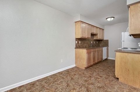 a kitchen with wooden cabinets and a stove and a refrigerator